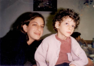 Sitting and holding her youngest sister, Haya Elisheva, whose blindness and multiple disabilities were a major factor in Malki developing a heightened sensitivity for special needs children like her sister.