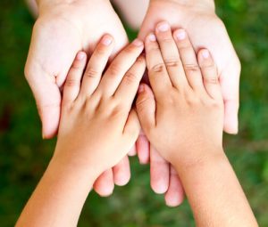 parent supporting child's hands