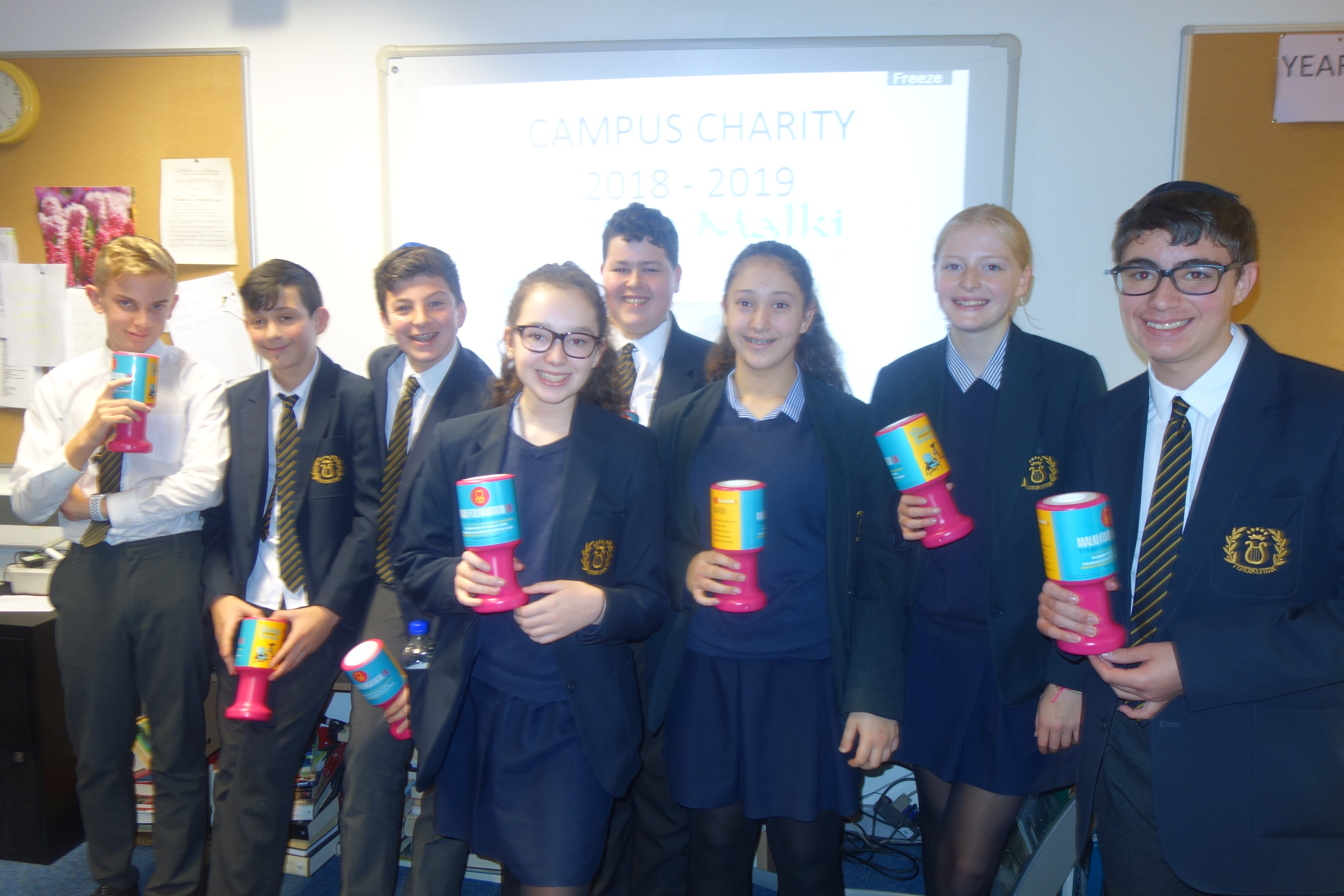 Students holding charity bins